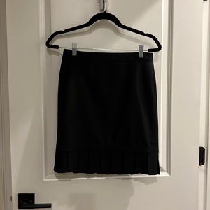 Black Express mini skirt with pleated hem, zipper in the back super stretchy.